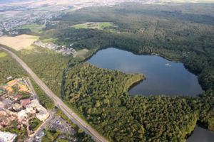 Luftaufnahme eines Ville-Sees am Rand der Ortschaft